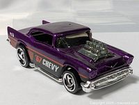 Front three-quarter view showing purple body, chrome bumper, exposed engine