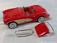 Overall view of red Franklin Mint Corvette with detachable windshield frame and hardtop displayed