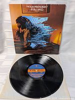 Front of sleeve with record partially exposed