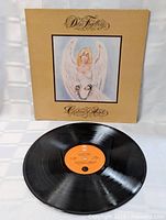 Front cover artwork with chained angel illustration and record displayed