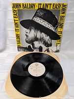 Vinyl LP on plain background with sleeve visible, shows record surface and label