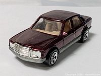 Front three-quarter view of metallic burgundy Hot Wheels Mercedes-Benz 380 SEL