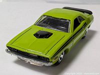 Front three-quarter view of lime-green Hot Wheels Dodge Challenger showing hood scoop and grille