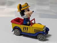 Left side view of die-cast Mickey Mouse roadster showing graphic and colors