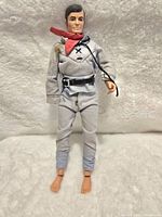 Front view of The Lone Ranger action figure showing facial details, red scarf, gray cloth outfit, black belt, and missing left hand with cord attached.