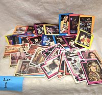 A spread of collectible trading cards including multiple Star Wars themed cards and music artist cards on a white background with a blue 'Lot 1' tag