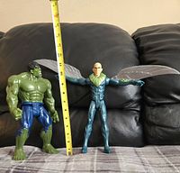 Both 12-inch Marvel Titan Heroes action figures, Incredible Hulk and Vulture with wings extended, shown side by side with measuring tape for scale.