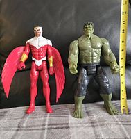 Two Marvel Titan figures, Falcon and Hulk, side by side with a tape measure showing about 12 inches tall each.