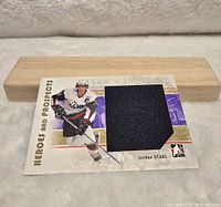 Front view of NHL Heroes and Prospects Jordan Staal hockey card with black fabric jersey piece visible.