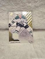 Front of Upper Deck Jason Spezza hockey card showing player image and embedded jersey piece.