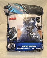 Photo of the folded Black Panther reversible comforter in package showing Marvel Avengers branding and Black Panther design, with twin/full size indicated.