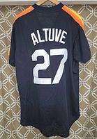 Back view of navy blue Mitchell & Ness Houston Astros jersey with 'ALTUVE' and number 27 in white letters.