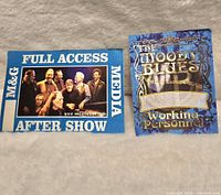 Front view of two backstage passes. Left pass is Willie Nelson full access media after show pass. Right pass is Moody Blues Europe tour working personnel pass.