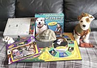 Overall grouping of Wishbone collectibles including board game, cap, stuffed toys, and cloth/paper set