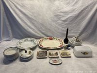 Full view of lot showing various plates, platters, bowls, ashtrays, covered dishes, and an atomizer