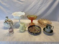 Full view of all eight items in the lot showing arrangement and colors.