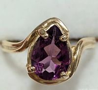 Top view of pear-shaped purple tourmaline in 14KT gold prong setting