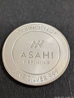 Obverse side of the silver coin with Asahi Refining logo and purity markings.