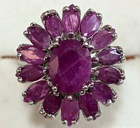 Top view showing the oval ruby cluster setting on the silver ring