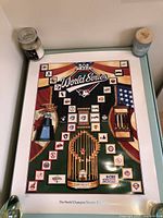 Photo showing the full 1992 World Series poster with logos of MLB teams, championship trophies and title.