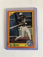 Front of 1990 Score baseball card showing Eric Lindros swinging a bat, with Toronto Blue Jays logo and orange border.