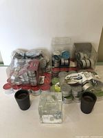 Top-down view of the lot showing packs of various tea light candles and three candle holders
