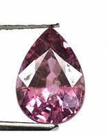 Close-up front view of this pear-shaped Rhodolite Garnet, highlighting its faceting, color, and surface inclusions.