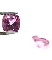 Close-up image of the pink mystic topaz gemstone held by tweezers showing cushion cut shape and rich pink color.