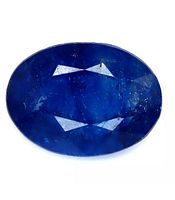 Top view showing the oval cut of the blue sapphire with deep blue color and internal inclusions.