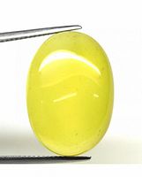 Close-up front view of the yellow oval chalcedony cabochon gemstone held by tweezers, showing smooth polished surface and yellow coloration with slight inclusions.