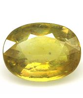 Close-up photo of 2.60 Ct. oval faceted natural yellow sapphire gemstone showing its transparent medium yellow color and internal inclusions.