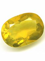 Oval cut yellow opal gemstone with faceted surface and translucent yellow color, approximately 8 x 12 mm.