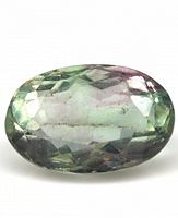 Top view of the oval cut bi-color fluorite gemstone showing its faceted surface and color gradient from green to purple.