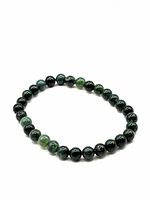 Full view of the green jade bead bracelet showing dark and light green polished round beads.