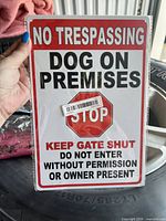 Photo of new metal sign still in original packaging, showing clear warning text and stop sign graphic.