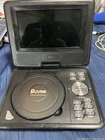 Front view of open Buyee portable DVD player showing the screen, DVD compartment, and control buttons.