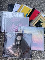 Photo showing a collection of music CDs, some still sealed, featuring artists such as Sonny Rollins and various others, indicating a mixed music CD bundle.