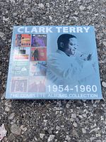 Photo of Clark Terry CD collection box set on outdoor surface showing box front art and multiple album covers included.