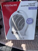 Photo of the Frigidaire tabletop adjustable heater packaging showing product image, brand, and key features such as heating capacity and overheat protection.