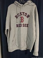 Front view of grey Boston Red Sox hoodie with logo and text on front.