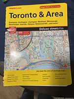 Front cover of the spiral-bound deluxe street atlas with map preview and title.
