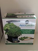 Front view of the boxed AeroGarden Smart Countertop Garden by Miracle-Gro showing product branding and features.