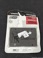 Front of the package showing the Kingston A400 SSD, the 120GB capacity, SATA 3.0 speed and product branding. Package bears signs of wear and tear but the drive is sealed inside.