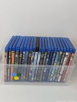 Blu-Ray movie collection stored in a clear plastic bin showing all spine covers.