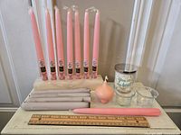 Full lot showing candles including pink taper candles, gray candles, resin holder, and decorative jar candle