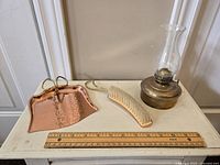 Full set on white table including copper dust pan, brush, and brass oil lantern with ruler for scale.