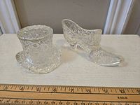 Photo showing the top hat and glass slipper pieces side by side with measurement scale.