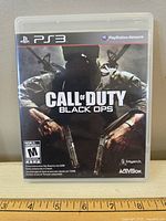 Front cover of the Call of Duty Black Ops game case for PS3 showing cover art, ESRB rating, and logos.