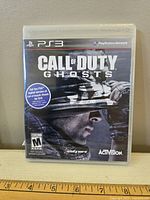 Front view of sealed Call of Duty Ghosts PS3 game case showing cover art and branding.