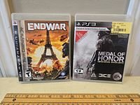 Front view of both PS3 games, EndWar and Medal of Honor Limited Edition, showing full cover art and condition.